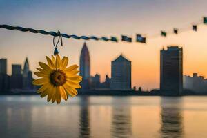 sunflower hanging from a rope in front of a city skyline. AI-Generated photo