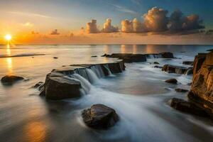 a beautiful sunset over the ocean with rocks and water. AI-Generated photo