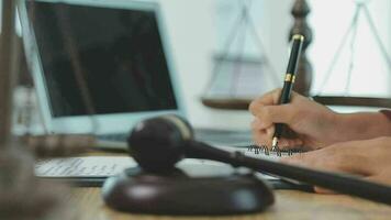 Business and lawyers discussing contract papers with brass scale on desk in office. Law, legal services, advice, justice and law concept picture with film grain effect video