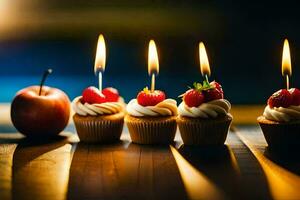 four cupcakes with candles on top of them. AI-Generated photo