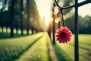 a red flower is hanging from a wire in a field. AI-Generated photo