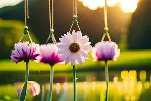 four flowers hanging from a string in front of a pond. AI-Generated photo