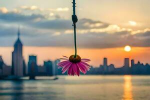 a flower hanging from a wire over a body of water. AI-Generated photo