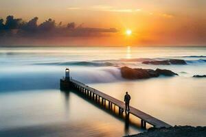 a man stands on a pier looking at the sun setting over the ocean. AI-Generated photo