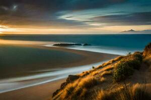the sun sets over the ocean and sand dunes. AI-Generated photo