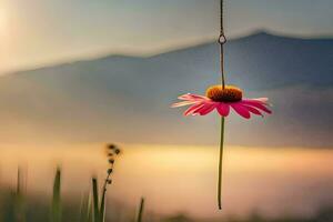 a pink flower hanging from a string in front of a mountain. AI-Generated photo