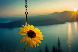 sunflower hanging from a chain with a lake in the background. AI-Generated photo