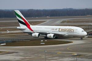 Emirates passenger plane at airport. Schedule flight travel. Aviation and aircraft. Air transport. Global international transportation. Fly and flying. photo