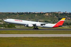 Iberia Airlines passenger plane at airport. Schedule flight travel. Aviation and aircraft. Air transport. Global international transportation. Fly and flying. photo