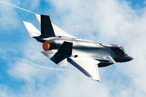 US Air Force USAF Lockheed F-35 Lightning II stealth fighter jet plane flying. Aviation and military aircraft. photo