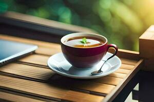 un taza de té en un de madera mesa con un ordenador portátil. generado por ai foto