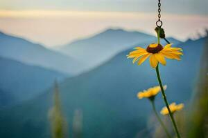 a yellow flower hanging from a chain in front of mountains. AI-Generated photo