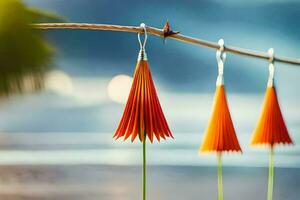 three orange paper flowers hanging on a wire. AI-Generated photo