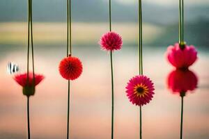 flowers hanging from a string in front of a lake. AI-Generated photo