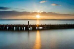 un hombre en pie en un muelle a puesta de sol. generado por ai foto