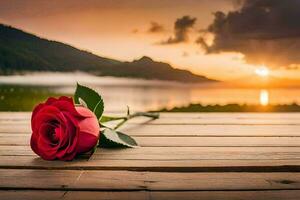 un soltero rojo Rosa se sienta en un de madera mesa en frente de un lago. generado por ai foto