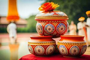 three colorful pots on a table with flowers. AI-Generated photo