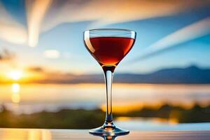 a glass of red wine on a table in front of the sunset. AI-Generated photo