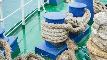 Mooring rope on soil, equipment on boat for parking in the port, naval rope white color on coil. photo