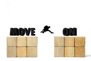 move on concept from boyfriend, girlfriend, job, problems and life. move on 3D text on the wooden cube with people or man jump to another cube photo