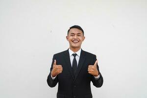 Portrait Young Asian businessman smiling happy face and thumb up, give praise, agree, isolated on white background photo