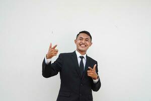 Portrait Young handsome Asian businessman pointing forward to choose you isolated on white background photo