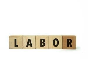 Labor word screen on the wooden cube on white background, international labor day, September 4. Copy space photo