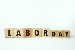 Labor day word screen on the wooden cube on white background, international labor day, September 4. Copy space photo