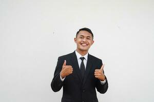 Portrait Young Asian businessman smiling happy face and thumb up, give praise, agree, isolated on white background photo