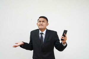 Handsome Asian young businessman confused with black suit, i don't know, on white background photo