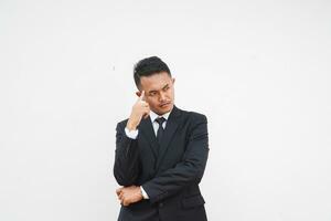 Handsome Asian young businessman thinking a idea with black suit, hand on chin, on white background photo