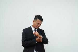 Portrait Young Asian businessman waiting gesture and look time at the watch , isolated on white background photo