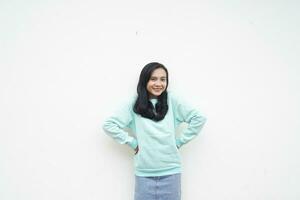 Portrait Indonesian beautiful woman wearing light blue sweater happy gesture with smile face isolated on white background photo