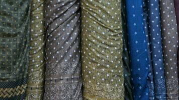 various types of rolled fabrics with polka dot patterns neatly arranged for the background photo