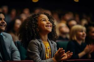A talented child actor taking a final bow eliciting a standing ovation from the audience photo