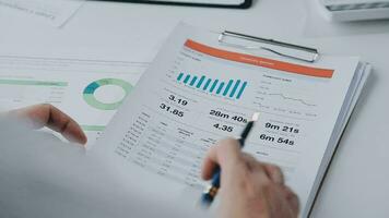 Group of confident business people point to graphs and charts to analyze market data, balance sheet, account, net profit to plan new sales strategies to increase production capacity. video