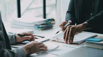 Group of confident business people point to graphs and charts to analyze market data, balance sheet, account, net profit to plan new sales strategies to increase production capacity. video