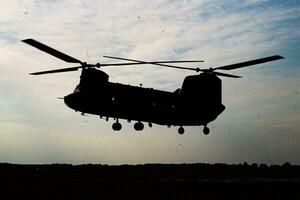 US Army Boeing CH-47 Chinook military helicopter at air base. Aviation and rotorcraft. Transport and airlift. Fly and flying. photo