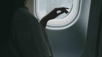 Plane cabin and a beautiful woman gazing out of the window video