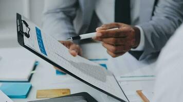 Group of confident business people point to graphs and charts to analyze market data, balance sheet, account, net profit to plan new sales strategies to increase production capacity. video