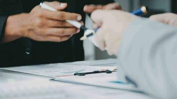 Group of confident business people point to graphs and charts to analyze market data, balance sheet, account, net profit to plan new sales strategies to increase production capacity. video