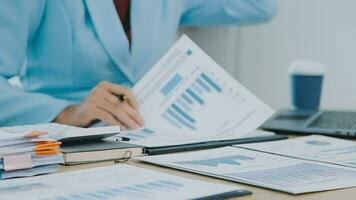 Financial Business team present. Business man hands hold documents with financial statistic stock photo, discussion, and analysis report data the charts and graphs. Finance Financial concept video