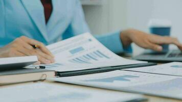 Financial Business team present. Business man hands hold documents with financial statistic stock photo, discussion, and analysis report data the charts and graphs. Finance Financial concept video