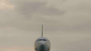 Modern jet flying overhead. In the middle of the frame. The plane is preparing to land. Airplane is landing. Footage video