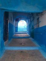 Trail among the beautiful blue houses in northern Morocco photo