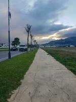 Sidewalk from the city side on a cloudy day photo