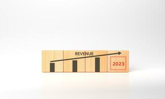 3d rendering Growth of revenue in 2023 concept. Analytics, plan, goals, strategy, achievement. Financial statement. Goals business 2023 success. wooden cubes with revenue and candlestick chart icons photo