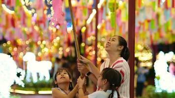 asiatisch Familien machen wünscht sich und hängen Laternen während das hundert tausend Laterne Festival oder yi peng Festival im Nord Thailand. video