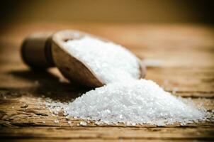 Salt background . On wooden table. photo