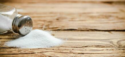 Salt background . On wooden table. photo